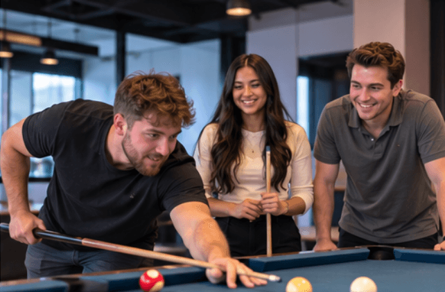 Revamped Marketing team members playing pool together
